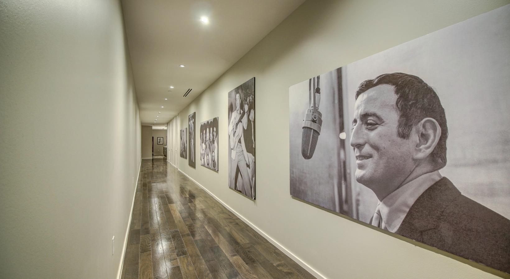 Spacious living areas to recline and recharge a man looking at a wall of art