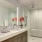 a bathroom with a tub sink and flowers