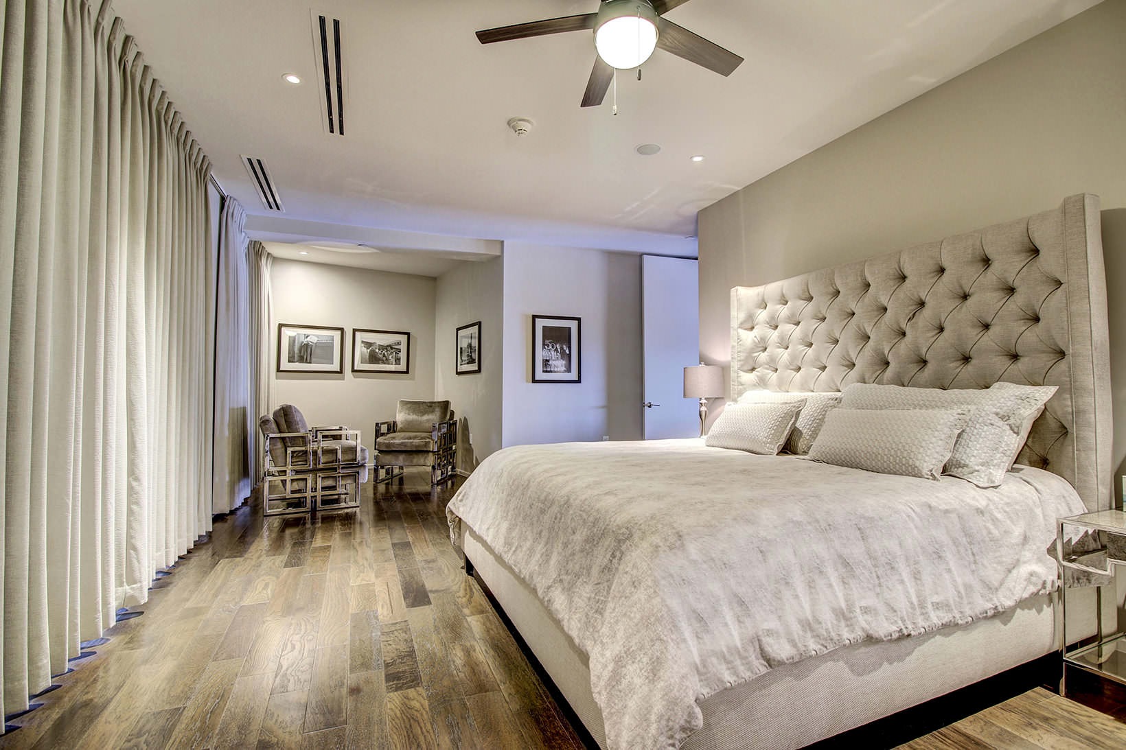 Bedroom spacious bedroom with ceiling fan and light fixture