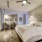 spacious bedroom with ceiling fan and light fixture