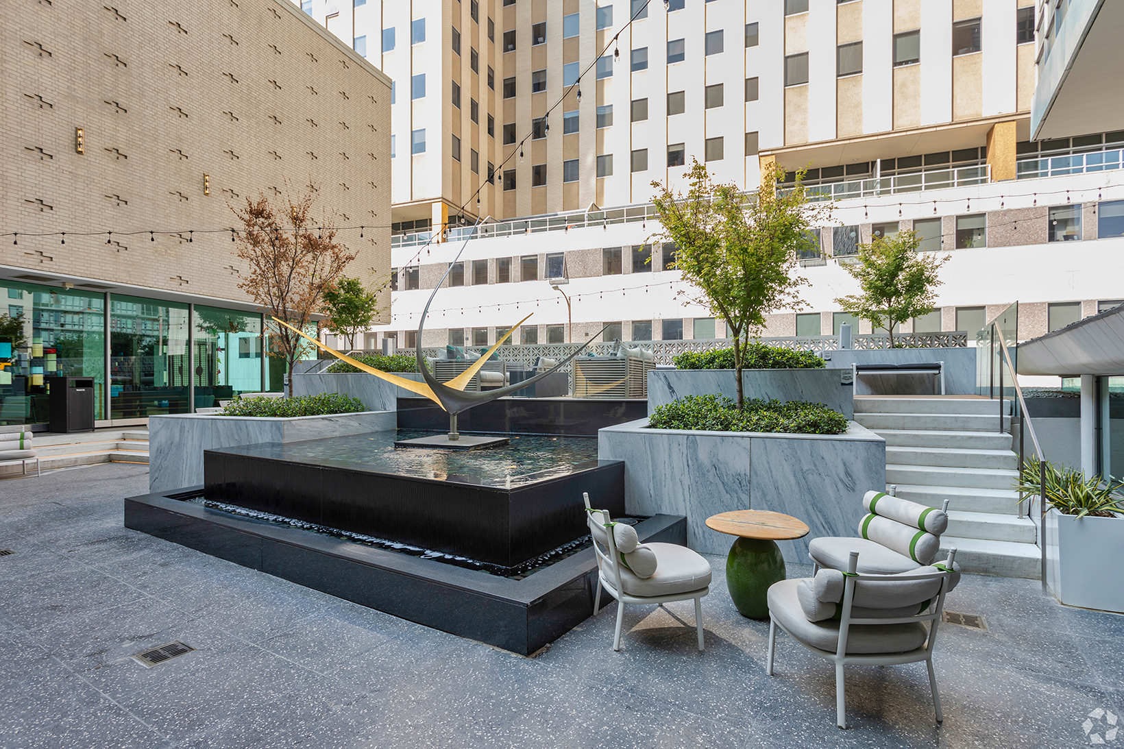 Courtyard courtyard with water fountain, table and chairs