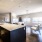 kitchen island overlooking spacious living room with large windows