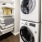 stacked washer/dryer units in bright laundry room