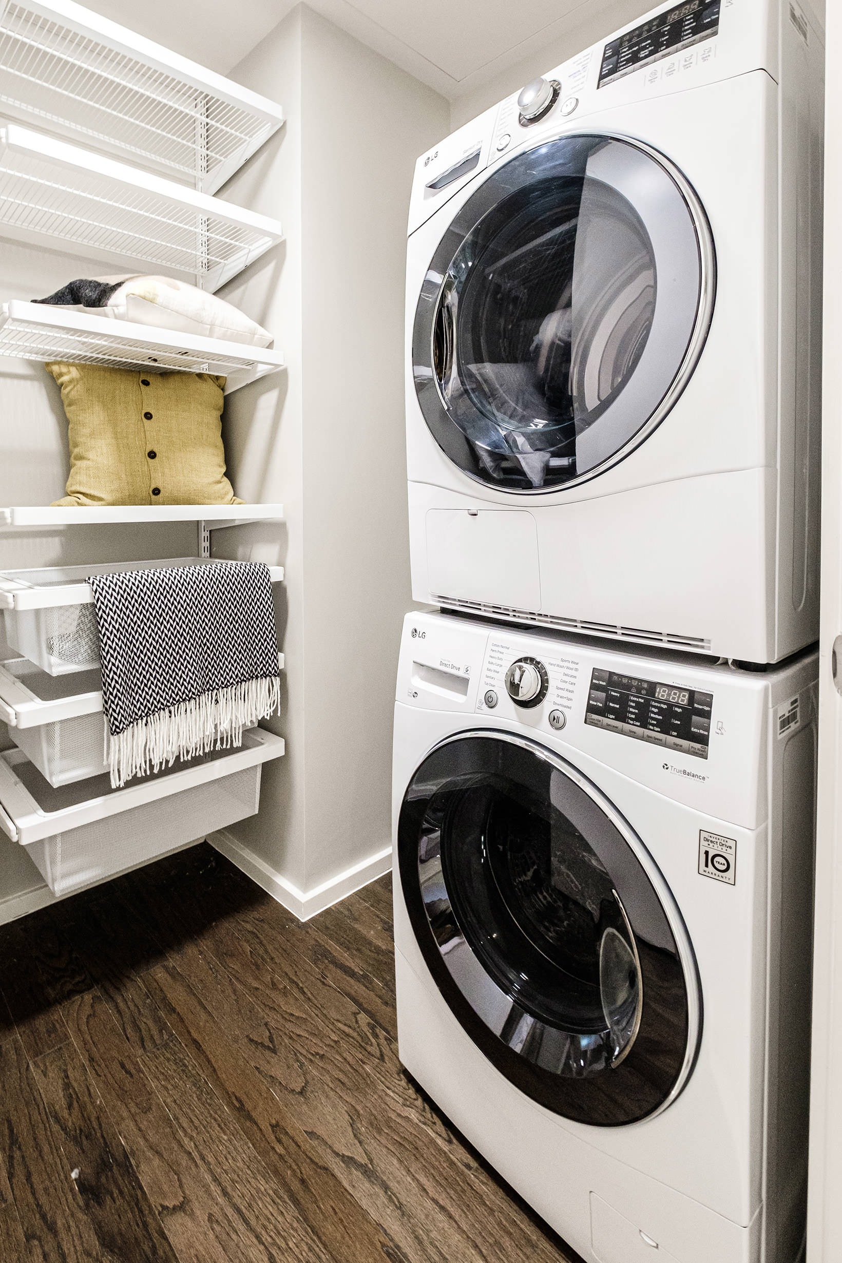 Laundry Room stacked washer/dryer units in bright laundry room